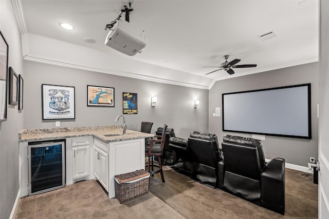 7305 Kingsbarns, The Colony, TX 75056 - carpeted cinema featuring beverage cooler, crown molding, a sink, ceiling fan, and baseboards