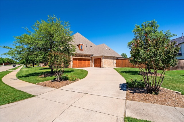 7305 Kingsbarns, The Colony, TX 75056 - view of front of house featuring driveway, stone siding, and an attached garage