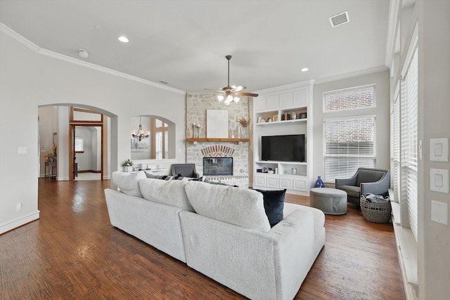 4219 Bal Harbour Ln, Frisco, TX 75033 - living area featuring crown molding, arched walkways, a fireplace, ceiling fan, and baseboards