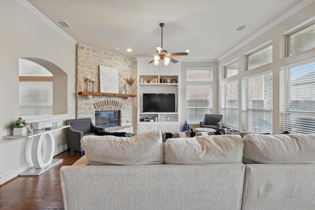 4219 Bal Harbour Ln, Frisco, TX 75033 - living room with crown molding, ceiling fan, a stone fireplace, dark wood-type flooring, and baseboards