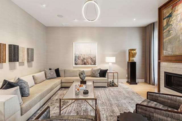 3645 Reagan St, Dallas, TX 75219 - living area featuring light wood finished floors, a premium fireplace, and recessed lighting