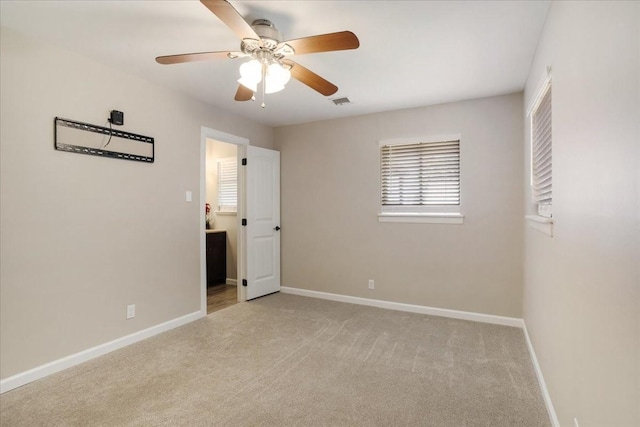 131 S Imperial Dr, Denison, TX 75020 - unfurnished bedroom featuring light carpet, baseboards, and ceiling fan