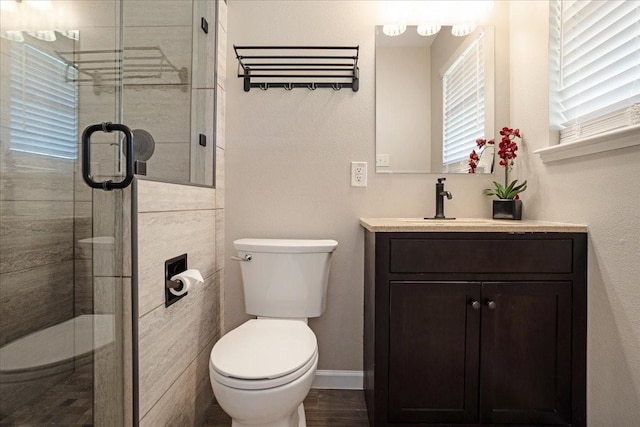 131 S Imperial Dr, Denison, TX 75020 - full bathroom featuring toilet, vanity, a stall shower, and baseboards