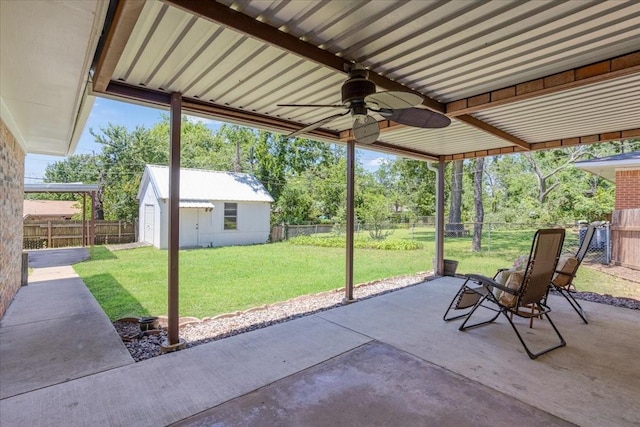 131 S Imperial Dr, Denison, TX 75020 - view of patio featuring ceiling fan, an outdoor structure, and view of scattered trees