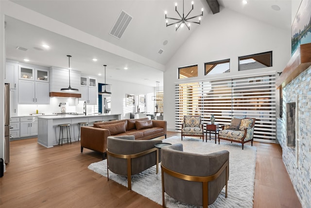 1907 Cedar Bluff Pkwy, Mansfield, TX 76063 - living room featuring high vaulted ceiling, light wood-style flooring, beamed ceiling, a chandelier, and recessed lighting