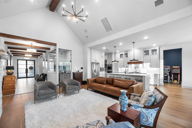 1907 Cedar Bluff Pkwy, Mansfield, TX 76063 - living room with light wood-type flooring, beam ceiling, a chandelier, recessed lighting, and high vaulted ceiling