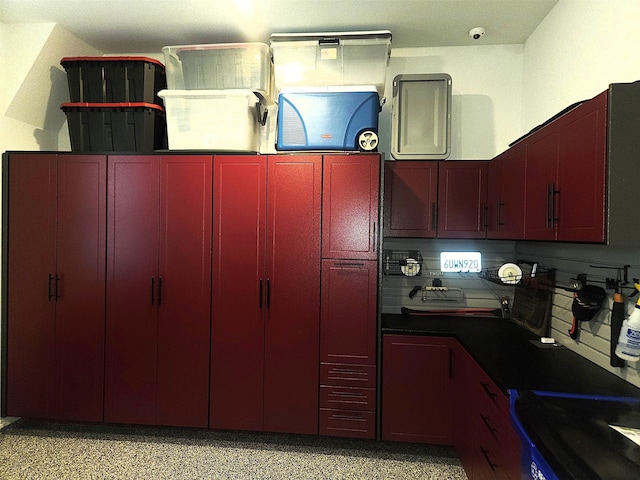 1907 Cedar Bluff Pkwy, Mansfield, TX 76063 - kitchen featuring reddish brown cabinets, dark aggregate flooring, red cabinetry, and dark countertops