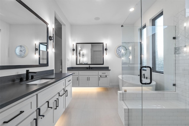 1907 Cedar Bluff Pkwy, Mansfield, TX 76063 - bathroom with a freestanding bath, a shower stall, two vanities, and tile patterned floors