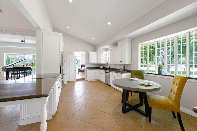 635 E Tripp Rd, Sunnyvale, TX 75182 - kitchen featuring stainless steel appliances, dark countertops, vaulted ceiling, white cabinets, and light tile patterned flooring