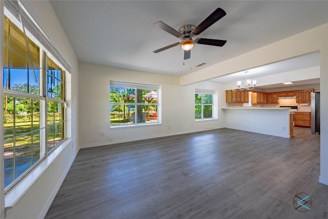 208 Lynn Creek Cv, Mabank, TX 75156 - unfurnished living room with a chandelier, ceiling fan, baseboards, and dark wood-style flooring