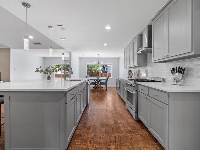 7724 Meadowhaven Dr, Dallas, TX 75254 - kitchen featuring appliances with stainless steel finishes, gray cabinetry, a sink, wall chimney range hood, and decorative backsplash