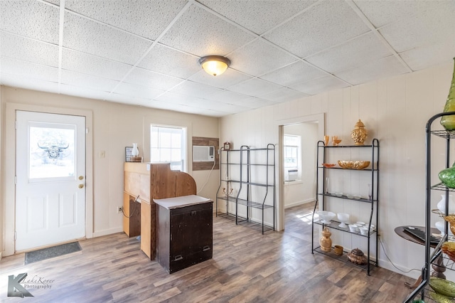 240 5th St, Hawley, TX 79525 - office featuring a paneled ceiling, wood finished floors, cooling unit, a wall mounted AC, and baseboards
