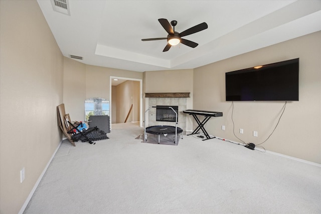8408 Island Ct, Fort Worth, TX 76137 - living area with carpet flooring, ceiling fan, a fireplace, baseboards, and a tray ceiling