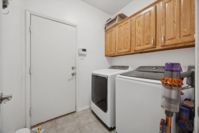 8408 Island Ct, Fort Worth, TX 76137 - laundry room featuring separate washer and dryer, cabinet space, and light tile patterned flooring