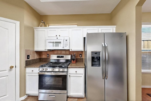 4533 Crooked Ridge Dr, The Colony, TX 75056 - kitchen with appliances with stainless steel finishes, white cabinets, tasteful backsplash, and baseboards