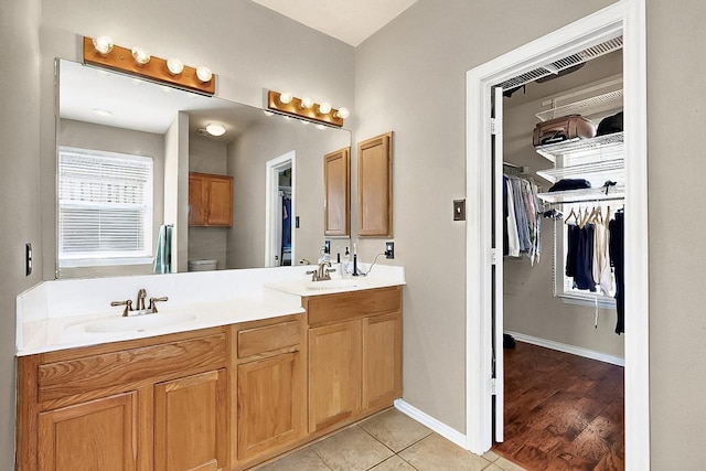 4533 Crooked Ridge Dr, The Colony, TX 75056 - full bathroom with double vanity, toilet, a spacious closet, baseboards, and tile patterned floors