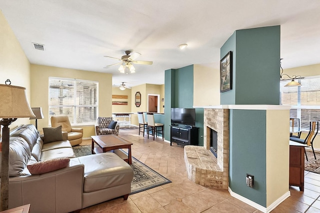 4533 Crooked Ridge Dr, The Colony, TX 75056 - living area featuring a ceiling fan, healthy amount of natural light, light tile patterned flooring, and baseboards