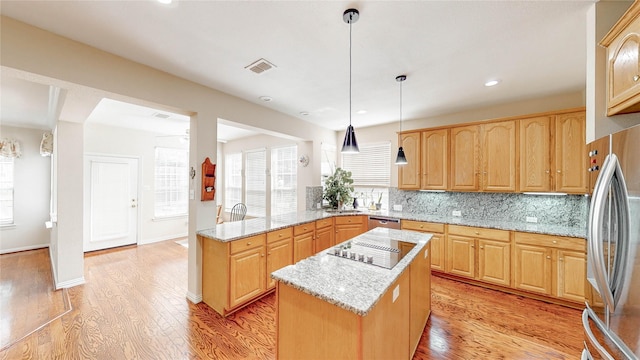 2700 Lake Crest Dr, Flower Mound, TX 75022 - kitchen with a peninsula, appliances with stainless steel finishes, light wood finished floors, tasteful backsplash, and recessed lighting