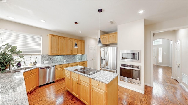 2700 Lake Crest Dr, Flower Mound, TX 75022 - kitchen with appliances with stainless steel finishes, plenty of natural light, arched walkways, a center island, and recessed lighting