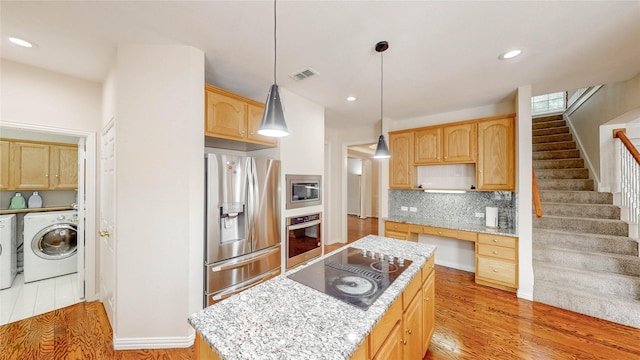 2700 Lake Crest Dr, Flower Mound, TX 75022 - kitchen featuring appliances with stainless steel finishes, washer / clothes dryer, a kitchen island, backsplash, and recessed lighting