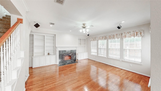 2700 Lake Crest Dr, Flower Mound, TX 75022 - unfurnished living room with stairs, ornamental molding, ceiling fan, a high end fireplace, and wood finished floors