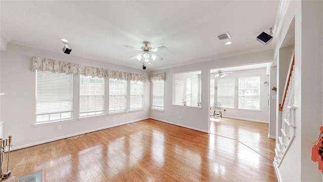 2700 Lake Crest Dr, Flower Mound, TX 75022 - spare room with ceiling fan, ornamental molding, healthy amount of natural light, light wood-style flooring, and baseboards
