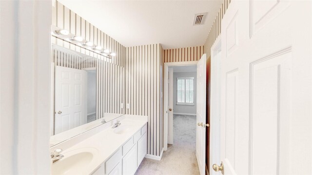 2700 Lake Crest Dr, Flower Mound, TX 75022 - full bathroom featuring double vanity, wallpapered walls, and baseboards