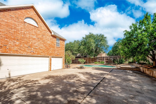 2700 Lake Crest Dr, Flower Mound, TX 75022 - view of side of property with brick siding, concrete driveway, and an attached garage