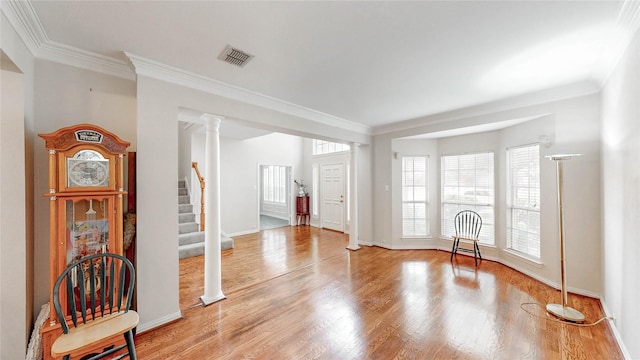 2700 Lake Crest Dr, Flower Mound, TX 75022 - empty room featuring stairway, ornamental molding, light wood-style flooring, baseboards, and decorative columns