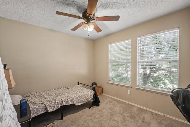 2200 Lookout Ln, Denton, TX 76207 - bedroom with multiple windows, carpet floors, a textured ceiling, baseboards, and a ceiling fan