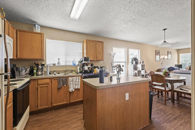 2200 Lookout Ln, Denton, TX 76207 - kitchen featuring range with electric stovetop, a sink, a textured ceiling, white microwave, and dark wood-type flooring