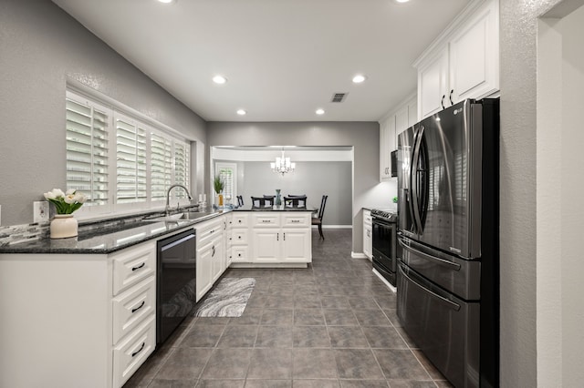 3428 Glade Creek Dr, Hurst, TX 76054 - kitchen featuring black appliances, a peninsula, a chandelier, recessed lighting, and white cabinets