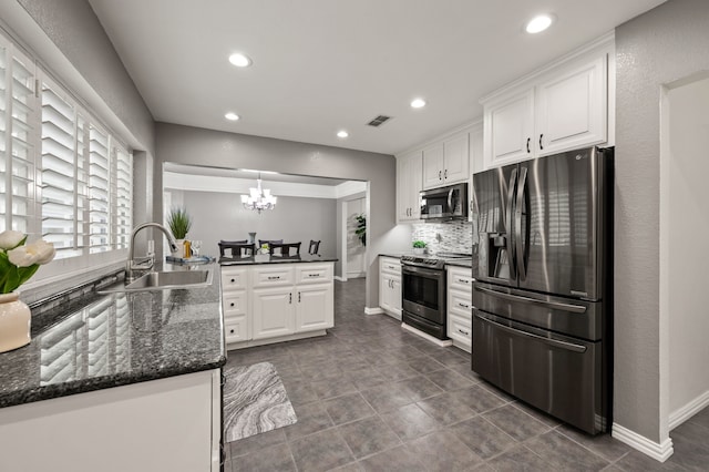 3428 Glade Creek Dr, Hurst, TX 76054 - kitchen featuring appliances with stainless steel finishes, a sink, a chandelier, white cabinets, and recessed lighting