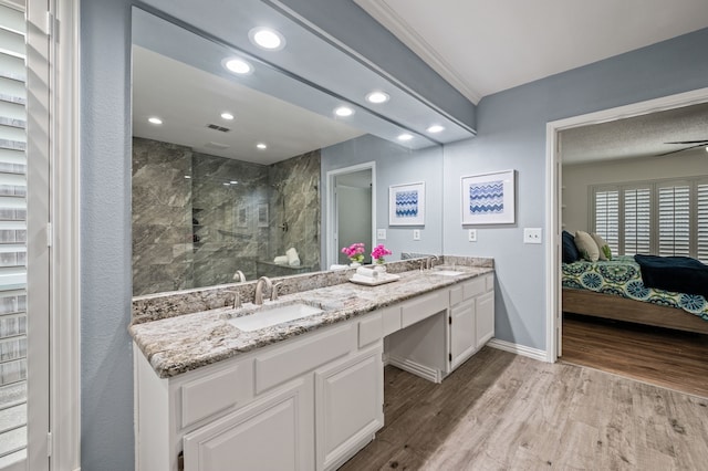 3428 Glade Creek Dr, Hurst, TX 76054 - bathroom with a marble finish shower, double vanity, wood finished floors, recessed lighting, and ensuite bathroom