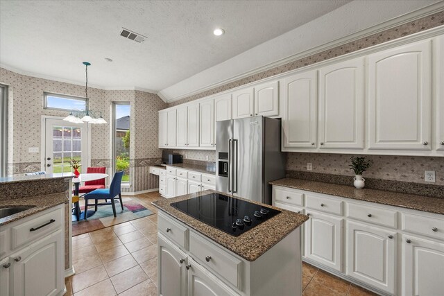 3134 Oak Dr, Rockwall, TX 75032 - kitchen with high end fridge, ornamental molding, black electric stovetop, wallpapered walls, and a chandelier