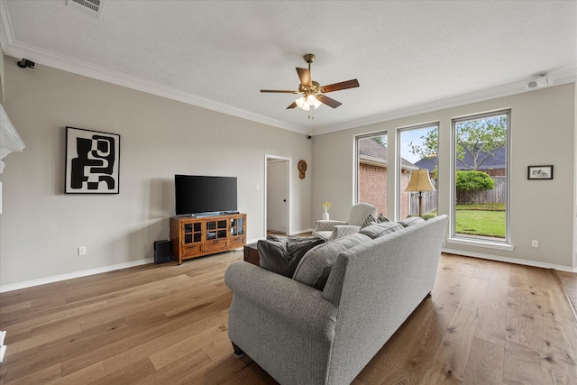 3134 Oak Dr, Rockwall, TX 75032 - living area with hardwood / wood-style flooring, baseboards, a ceiling fan, and ornamental molding