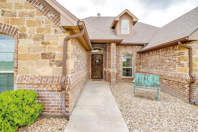 5633 Veal Station Rd, Weatherford, TX 76085 - entrance to property featuring roof with shingles, brick siding, and a patio