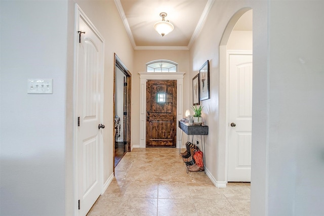 5633 Veal Station Rd, Weatherford, TX 76085 - foyer entrance with arched walkways, crown molding, baseboards, and light tile patterned floors