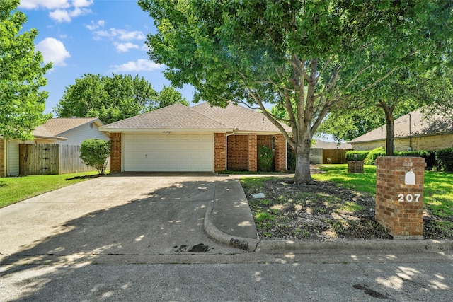 207 Johnston Blvd, Waxahachie, TX 75165 - view of front facade with a garage, brick siding, driveway, and roof with shingles