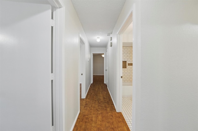 207 Johnston Blvd, Waxahachie, TX 75165 - corridor with wood finished floors, a textured ceiling, and baseboards