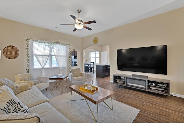 5201 Beaver Creek Ave, Denton, TX 76207 - living area with a ceiling fan, arched walkways, wood finished floors, and baseboards