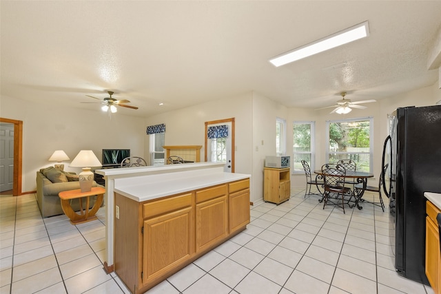 2207 Villanova St, Arlington, TX 76018 - kitchen featuring freestanding refrigerator, ceiling fan, light tile patterned flooring, and open floor plan