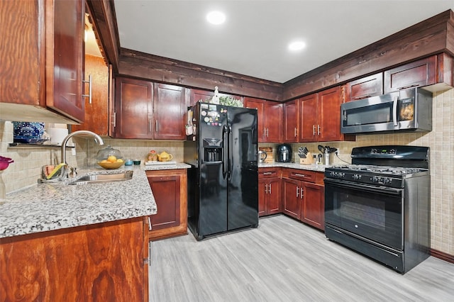 11514 Oakfield Dr, Balch Springs, TX 75180 - kitchen with black appliances, a sink, light wood finished floors, backsplash, and recessed lighting