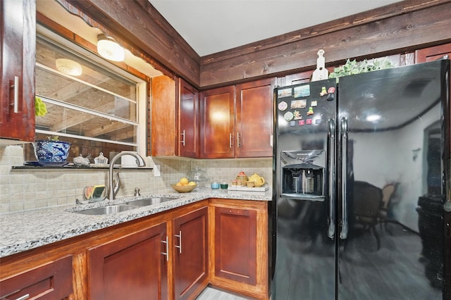 11514 Oakfield Dr, Balch Springs, TX 75180 - kitchen with a sink, black refrigerator with ice dispenser, decorative backsplash, and light stone countertops