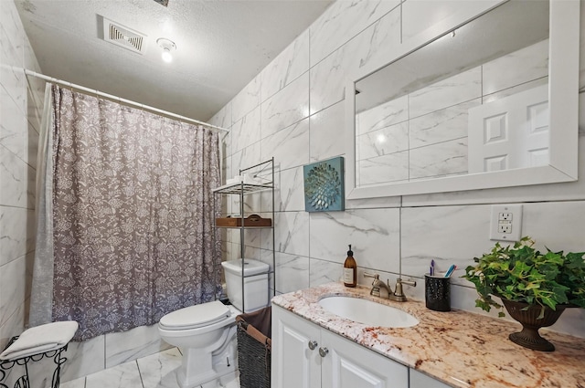 11514 Oakfield Dr, Balch Springs, TX 75180 - full bath with tile walls, marble look tile flooring, vanity, toilet, and a shower with curtain