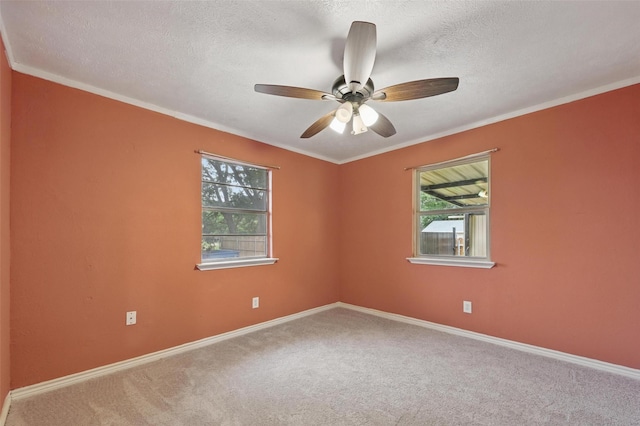 11514 Oakfield Dr, Balch Springs, TX 75180 - carpeted empty room with a textured ceiling, a ceiling fan, baseboards, and crown molding