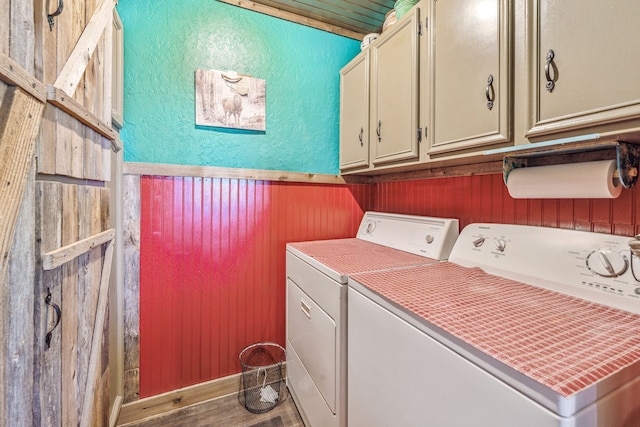 106 Hillcroft Dr, Weatherford, TX 76087 - washroom featuring cabinet space, washing machine and clothes dryer, wooden walls, a textured wall, and wood finished floors