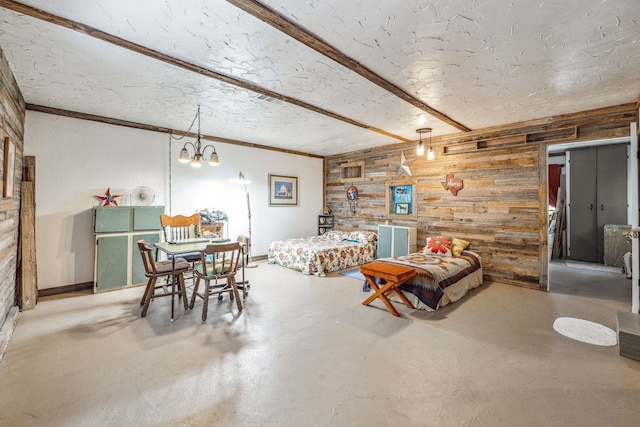 106 Hillcroft Dr, Weatherford, TX 76087 - living room with wooden walls, concrete floors, crown molding, and a chandelier