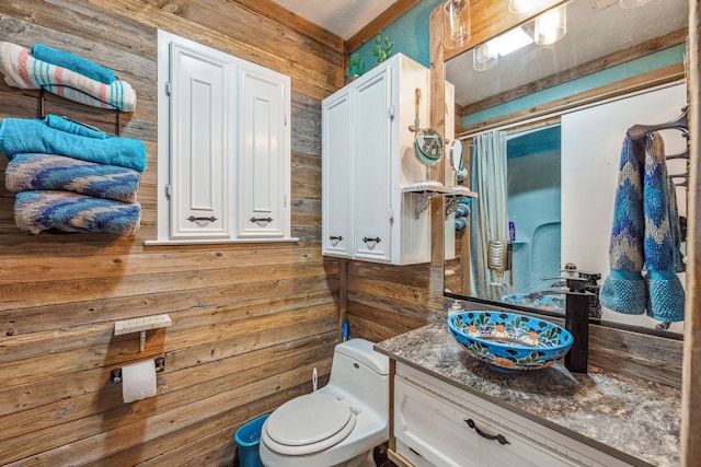106 Hillcroft Dr, Weatherford, TX 76087 - full bathroom featuring wood walls, toilet, and vanity