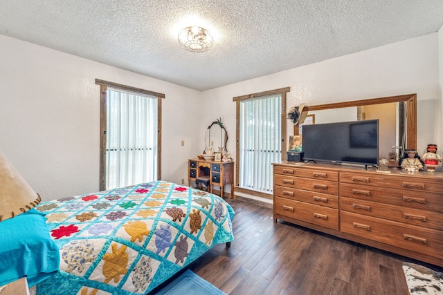 106 Hillcroft Dr, Weatherford, TX 76087 - bedroom with dark wood-style flooring and a textured ceiling